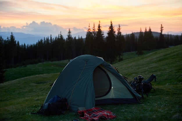 Shot of a tourist tent placed on top of a hill