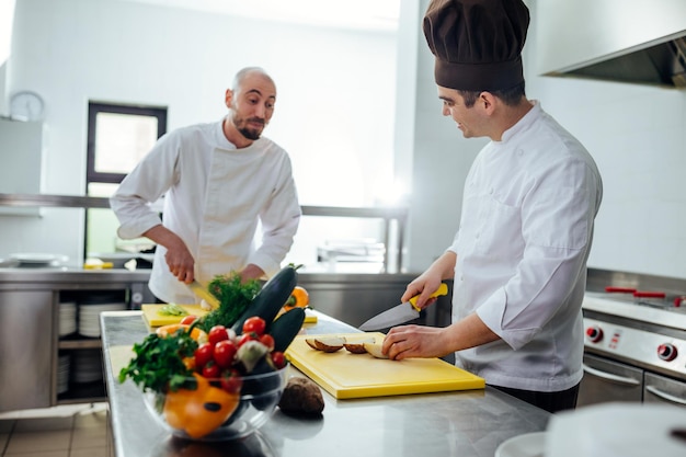 Shot of two young chefs in the kitchen