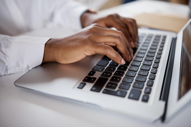 Shot of an unrecognisable businesswoman using a laptop in a modern office