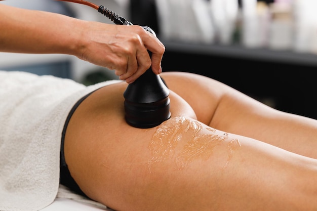 Shot of an unrecognizable woman getting an anti cellulite massage at the beauty salon. She have a vacuum treatment to fat reduction.