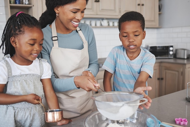Shot van een moeder die thuis bakt met haar kinderen