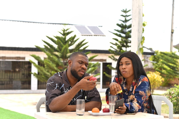 Photo shot of a woman using her cellphone while sitting in a cafe with her boyfriend