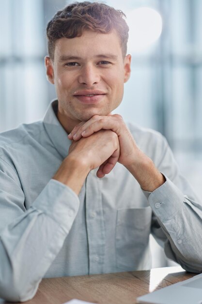 Shot of a young businessman using a laptop in a modern office