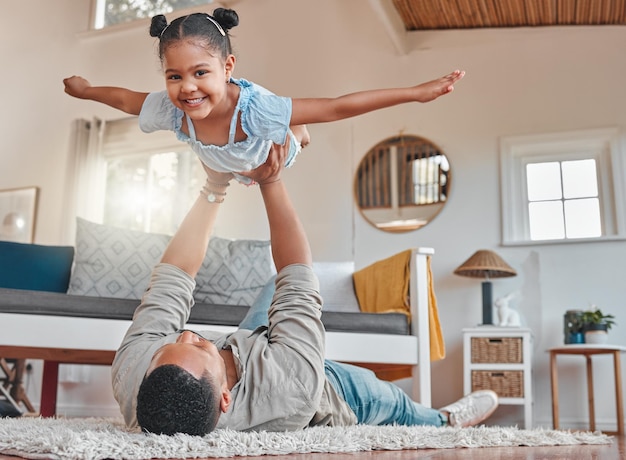 Shot of a young father and daughter bonding while playing on the floor at home