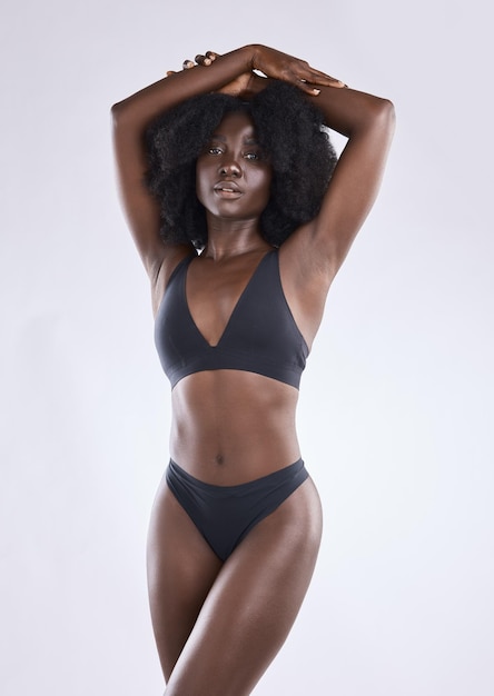 Shot of a young woman posing in her underwear against a studio background