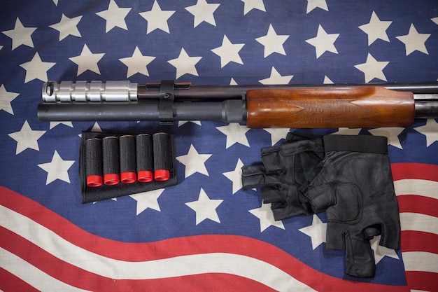 Photo shotgun american flag background.