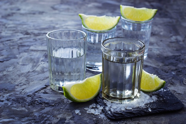 Shots of Mexican silver tequila with lime and salt. Selective focus
