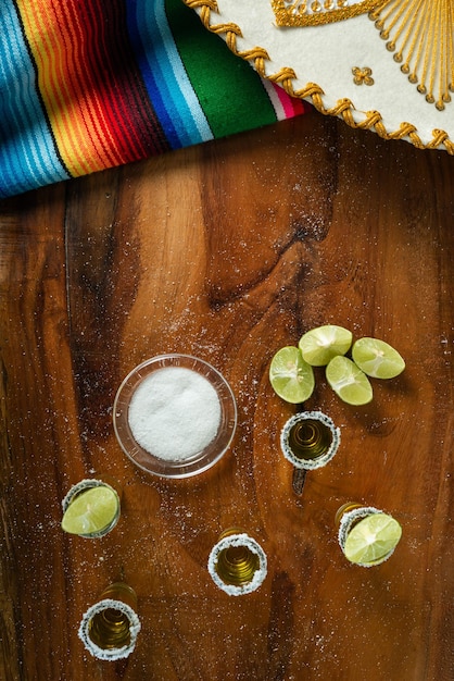 Photo shots of tequila with salt and lemon on a wooden table festive cinco de mayo background