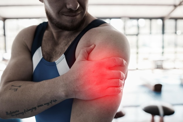 Shoulder pain sport injury and man with fitness muscle tension and hand gymnast at gym and red overlay Sports accident medical emergency and person at gymnastics competition and inflammation