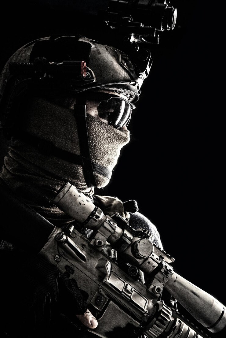 Photo shoulder portrait of army elite troops sniper antiterrorist tactical team marksman wearing helmet with thermal imager hiding face behind mask armed rifle with optical scope studio shoot on black