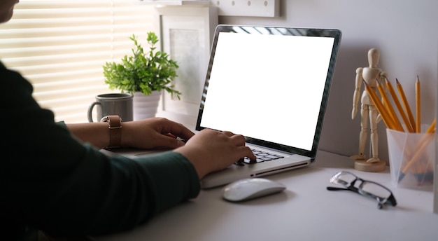 Over shoulder view of male freelancer working online typing business email on laptop computer