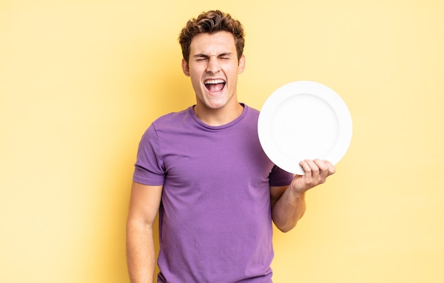 Shouting aggressively, looking very angry, frustrated, outraged or annoyed, screaming no. empty plate concept