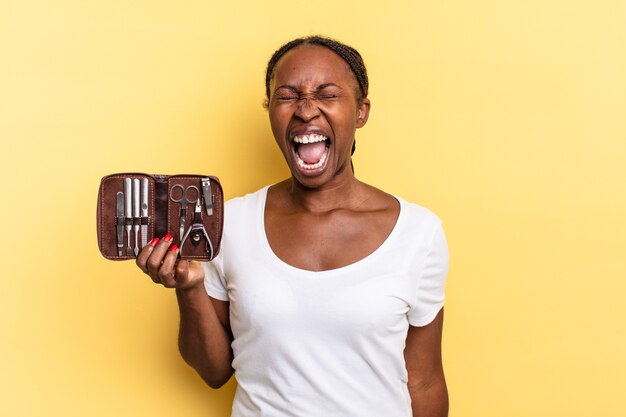 Shouting aggressively, looking very angry, frustrated, outraged or annoyed, screaming no. nails tools concept