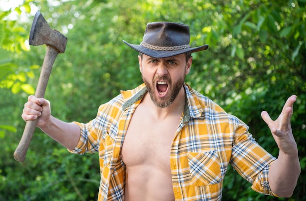 shouting angry lumberjack with axe wearing checkered shirt angry lumberjack with axe outdoor photo of angry lumberjack with axe angry lumberjack with axe