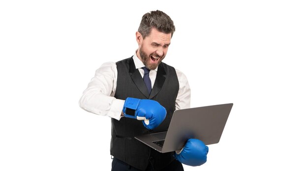 Shouting guy in boxing gloves and formalwear punch computer isolated on white cyber bullying