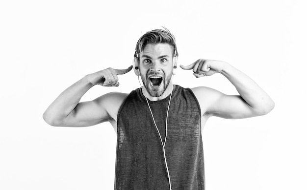 Shouting guy listening to music in stereo headset mp3 player sexy muscular man listen music on phone mp3 player man with mp3 player on phone isolated on white unshaven man in headphones