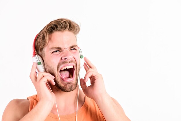 Shouting rock man relax playlist sexy muscular man listen music from playlist man relax in earphones isolated on white unshaven man relax with favorite song hipster fashion style