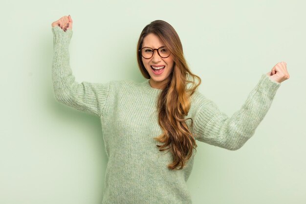 Shouting triumphantly looking like excited happy and surprised
winner celebrating