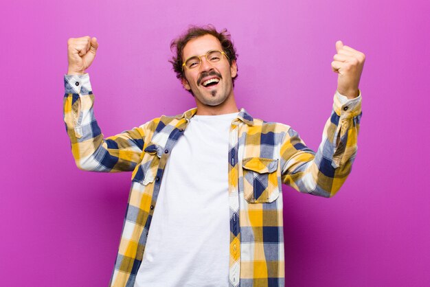 Shouting triumphantly, looking like excited, happy and surprised winner, celebrating