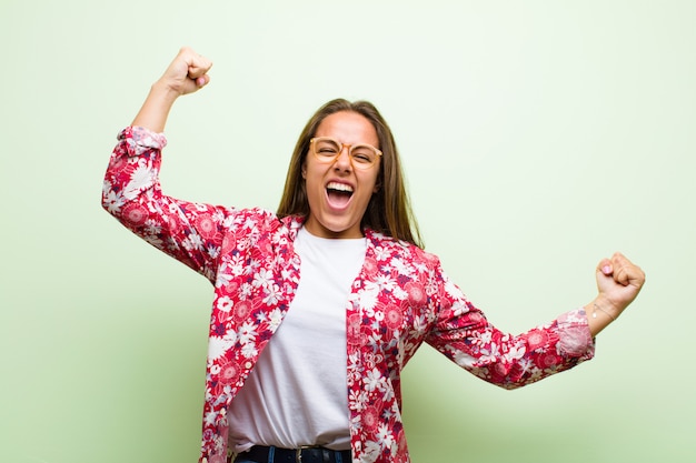 shouting triumphantly, looking like excited, happy and surprised winner, celebrating