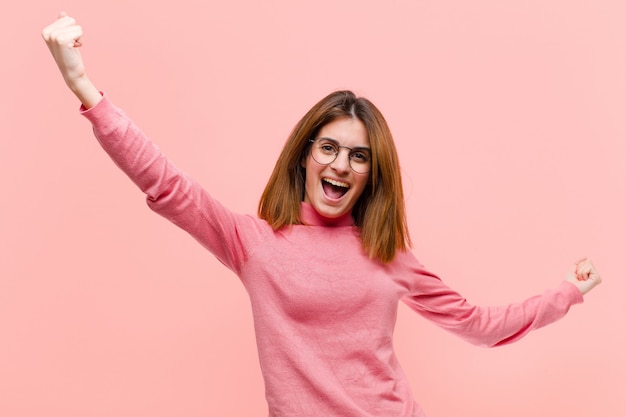 shouting triumphantly, looking like excited, happy and surprised winner, celebrating