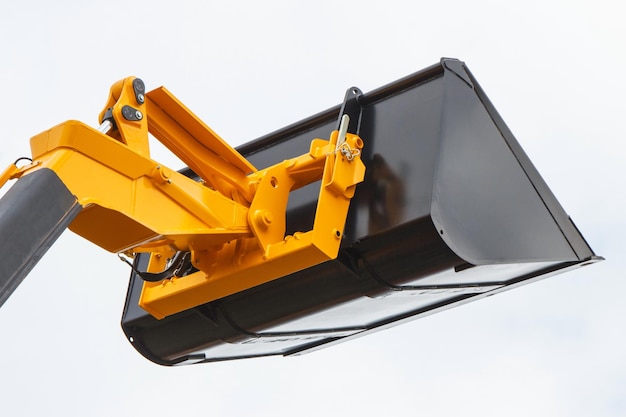 Photo shovel of excavator or bulldozer detail of part of hydraulic and pneumatic mechanism using in industrial machine white background