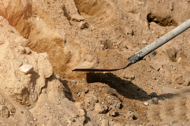 Shovel on a pile of gravel close-up