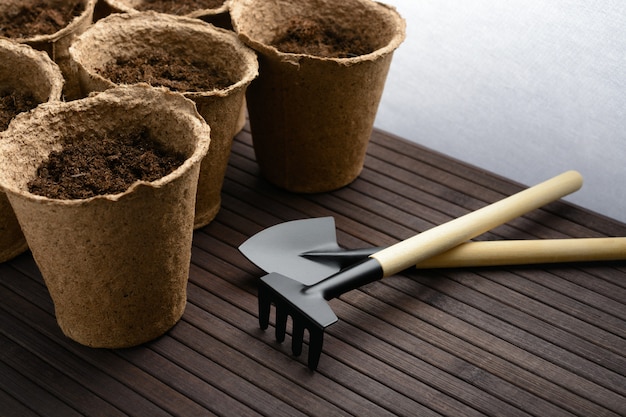 Shovel and a rake with peat pots