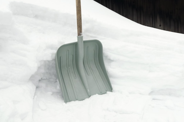 Shovel for snow next to snowdrift snow winter