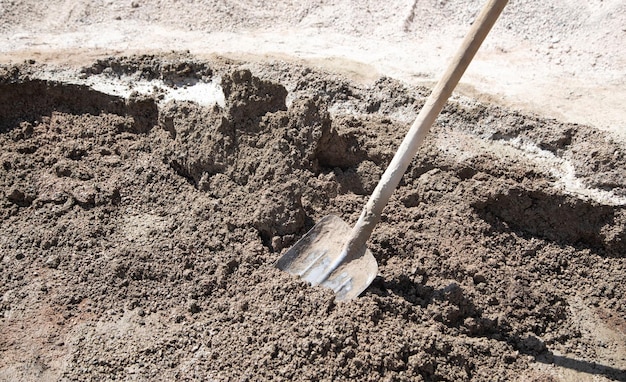 Shovel with a cement Construction site