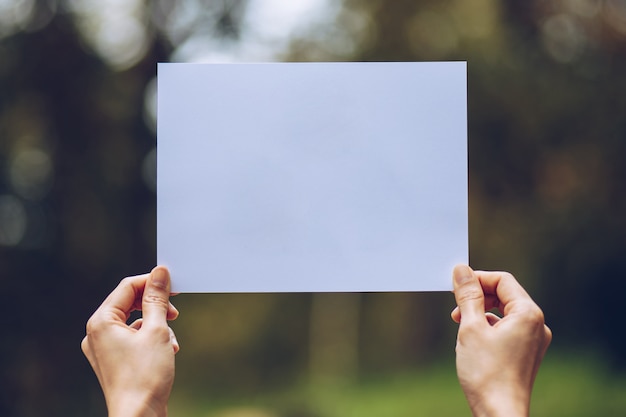 Show business paper in hand on nature