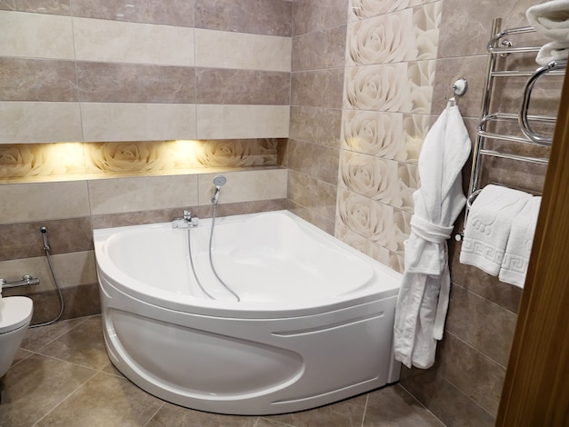 Shower and a bath in modern bathroom in hotel.