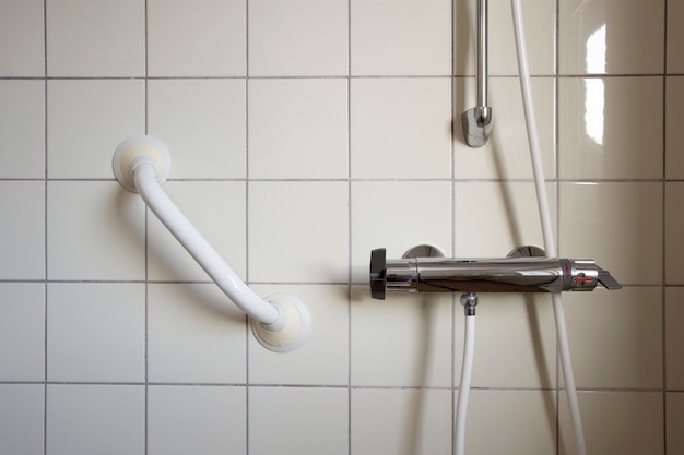 Shower and handrail grab bar for elderly people at the bathroom in hospital or retirement home