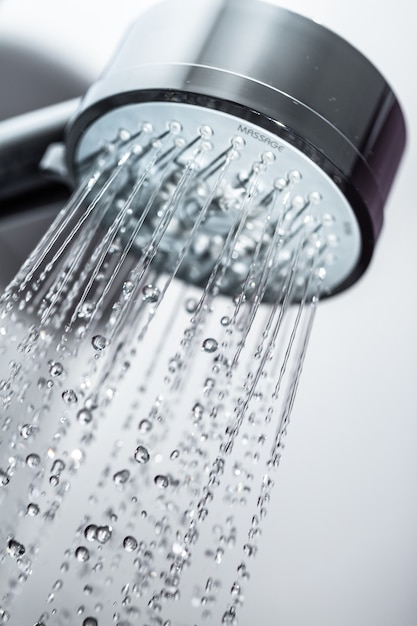 Shower Head with Water Stream on Grey Background