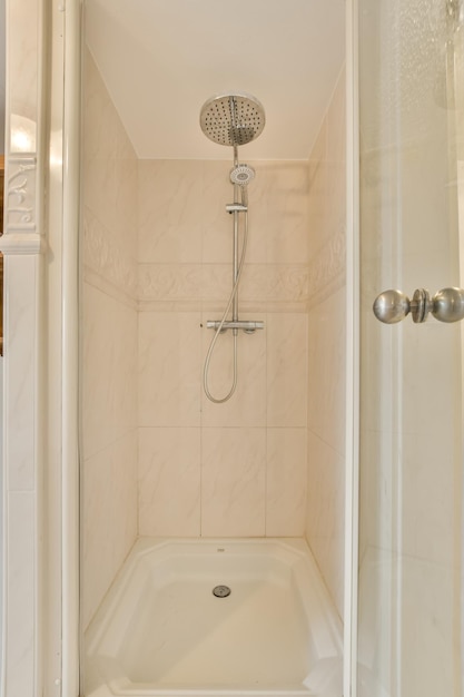 Shower room lined with beige tiles in brick style in a modern house