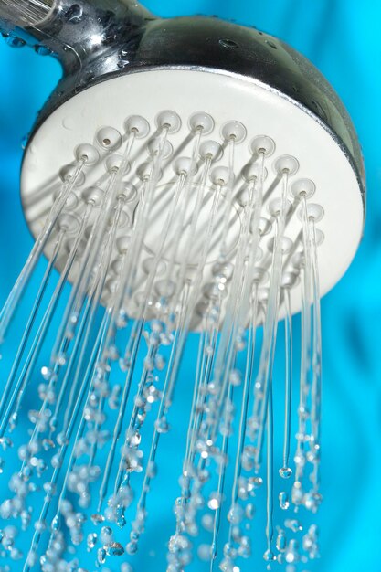 Shower with drops of water on a blue background.