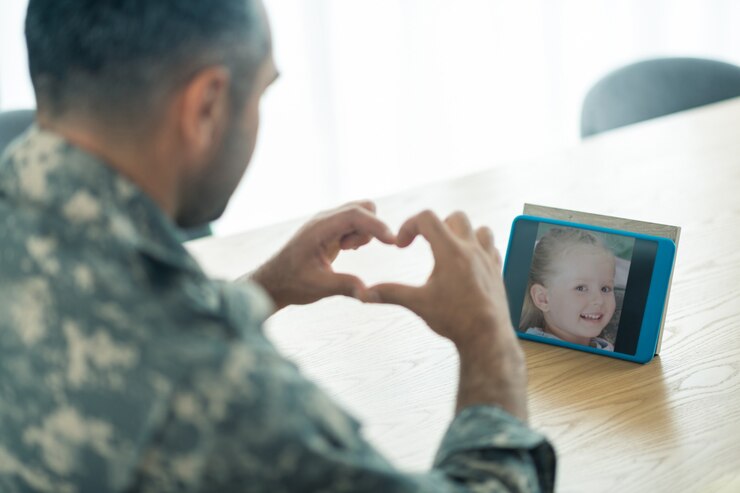 Father watching and talking to daughter on baby monitor