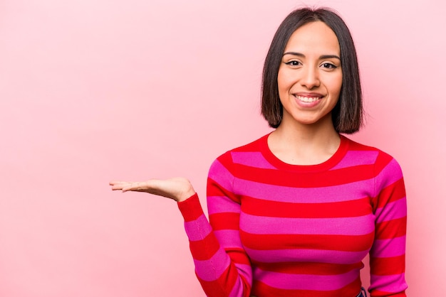 Showing a copy space on a palm and holding another hand on waist