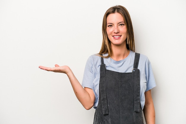 Showing a copy space on a palm and holding another hand on waist