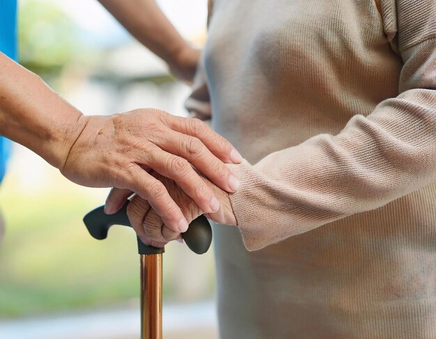 showing the hands of an old couple holding each other enjoying the cool morning weather