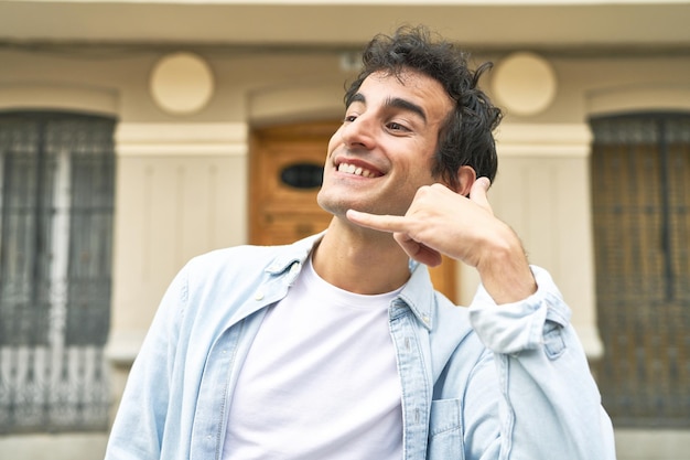 Showing a mobile phone call gesture with fingers