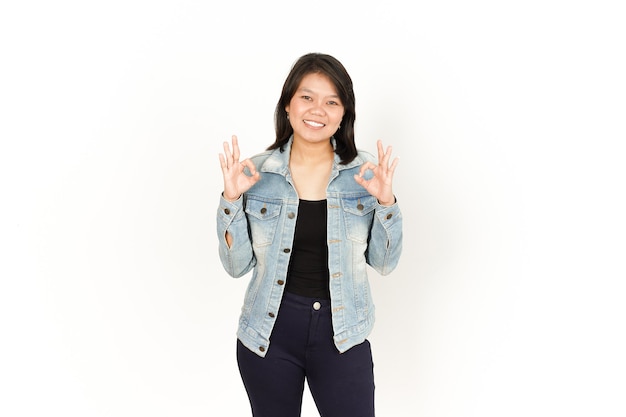 Showing Ok Sign of Beautiful Asian Woman Wearing Jeans Jacket and black shirt Isolated On White