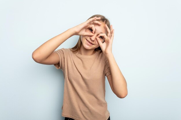 Showing okay sign over eyes