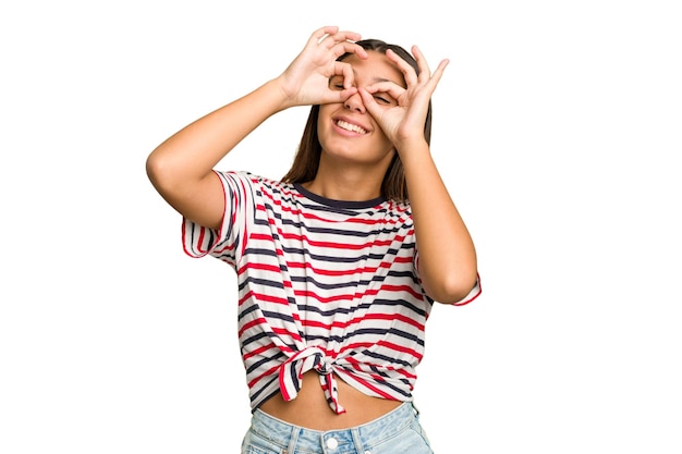 Showing okay sign over eyes