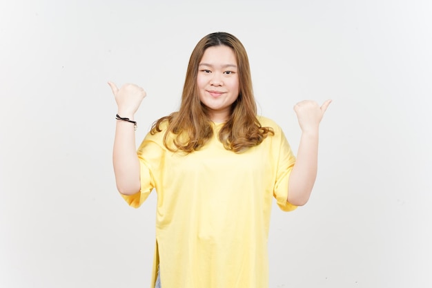 Showing and Pointing Two Product With Thumbs of Beautiful Asian Woman wearing yellow TShirt