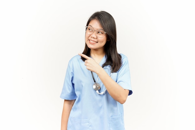 Showing Product and Pointing Side Of Asian Young Doctor Isolated On White Background