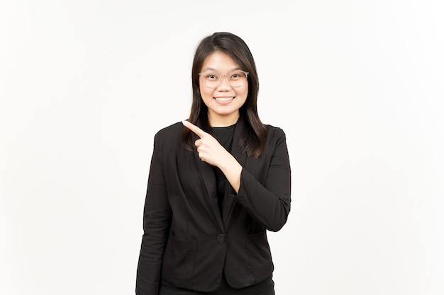 Showing Product and Pointing Side Of Beautiful Asian Woman Wearing Black Blazer Isolated On White