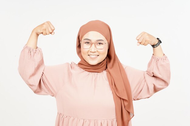 Showing strength arm of Beautiful Asian Woman Wearing Hijab Isolated On White Background