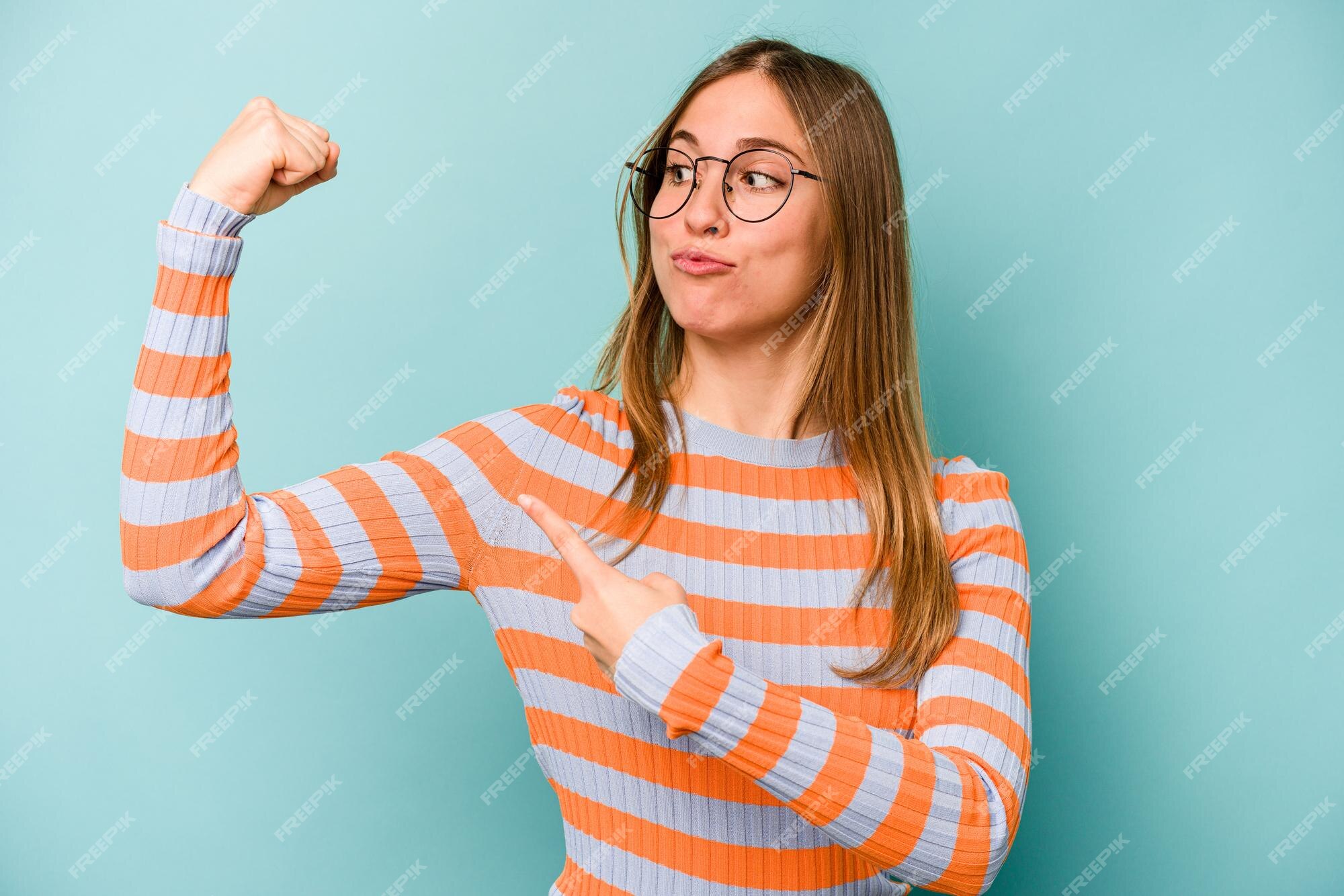 Muscular sporty lady posing with arms crossed Stock Photo by