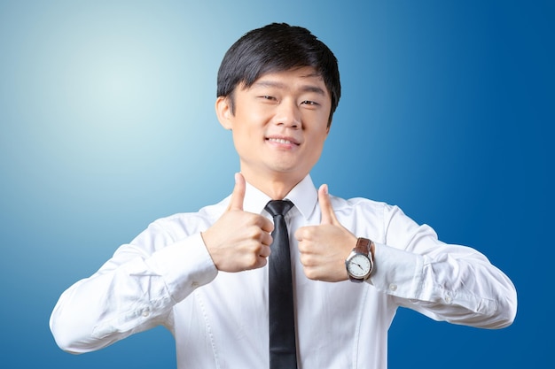 Showing thumbs young asian business man